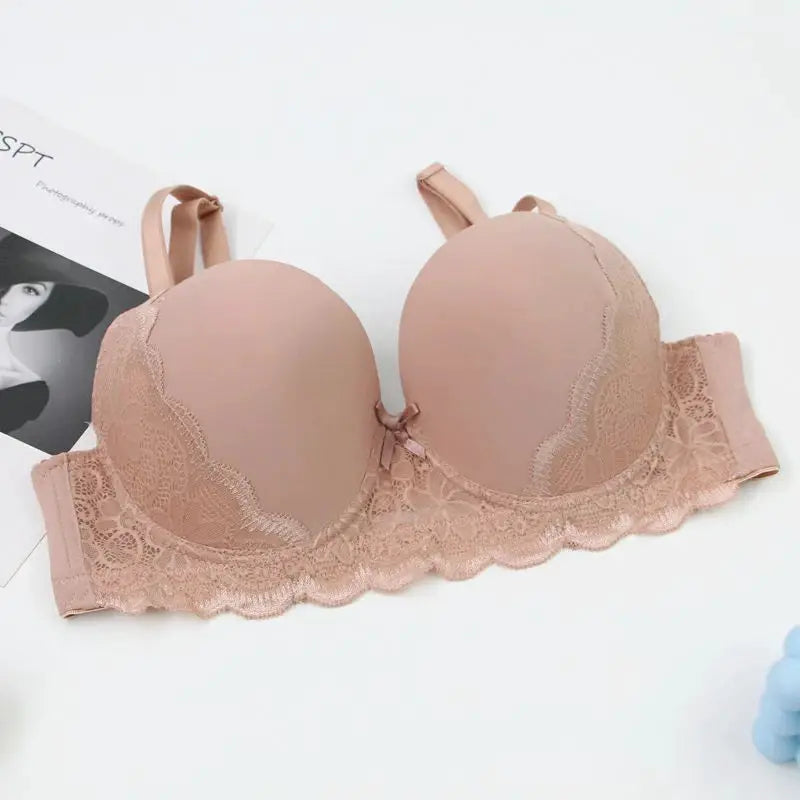 Push-up lace bra in blush pink with scalloped edges and wide floral lace band