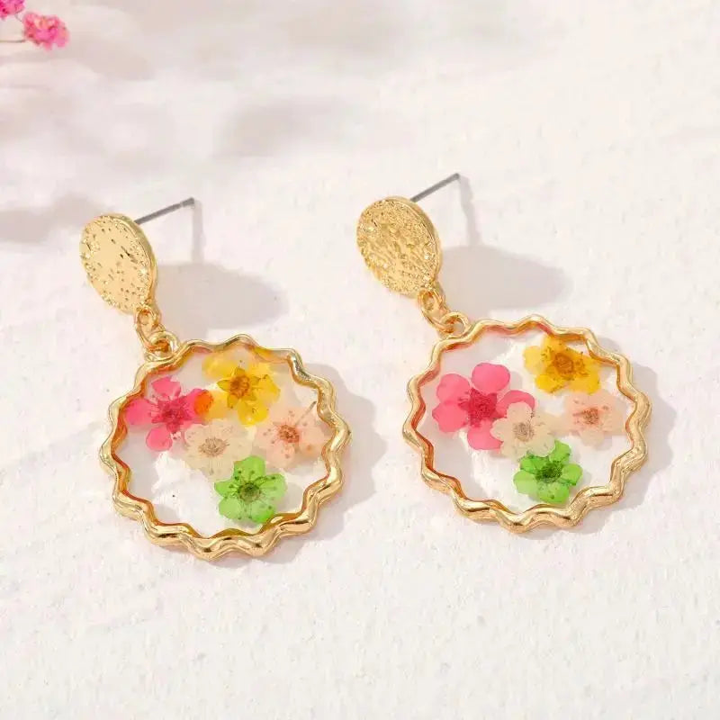 Flower dangle earrings with gold-tone scalloped frames and colorful pressed flowers encased in resin (pair)
