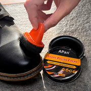 Faux leather shoe polishing kit with orange applicator and black jar of shoe polish cream