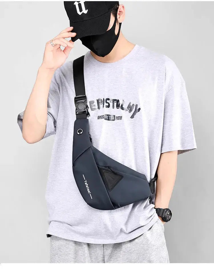 Sling chest bag in dark gray, compact crossbody anti-theft messenger bag worn across the chest.