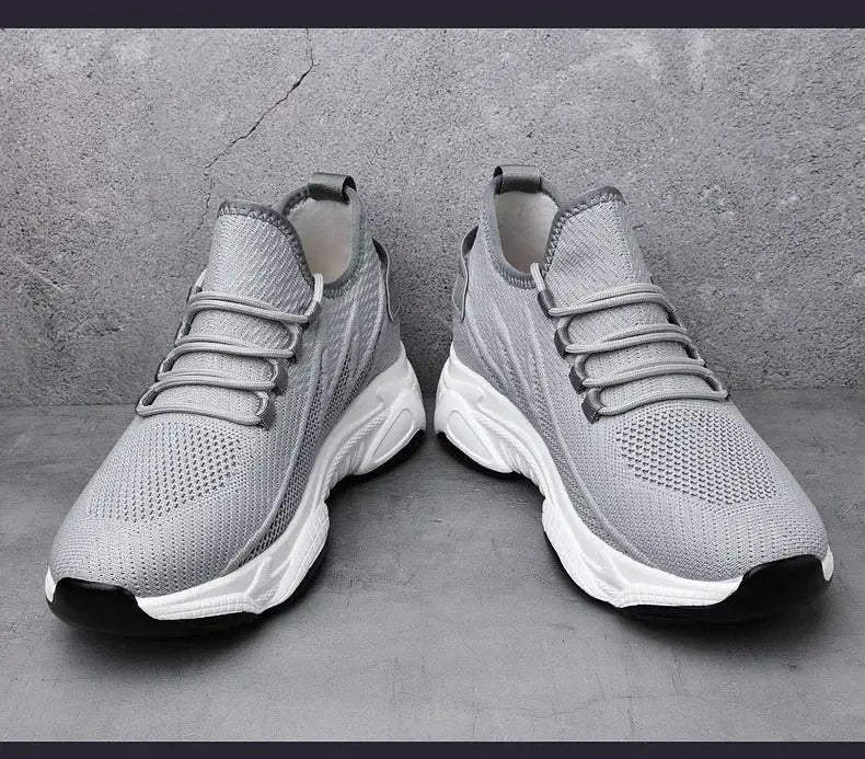 Pair of men's grey breathable knit sneakers with white chunky sole; height-increasing elevator shoes.