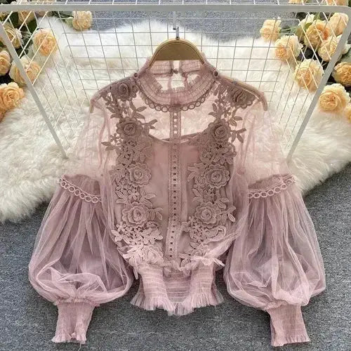 Lace puff long-sleeve blouse in pink mauve with sheer floral lace and high neckline.