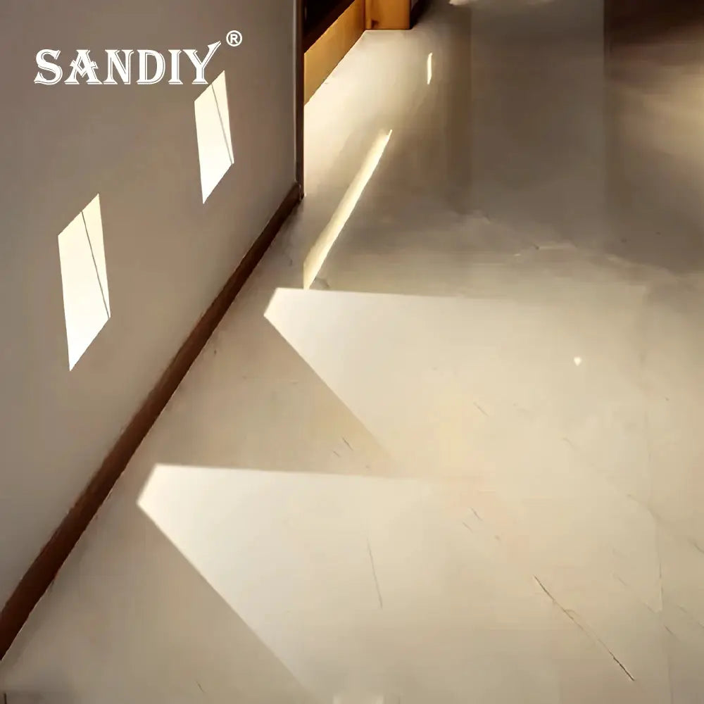 SANDIY wall sconce lamp logo on wall beside white staircase, rectangular light patterns.