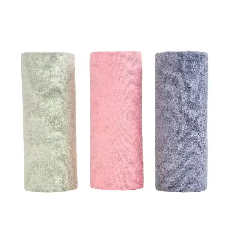 Three microfiber kitchen towel rolls in pastel green, pink, and lavender.