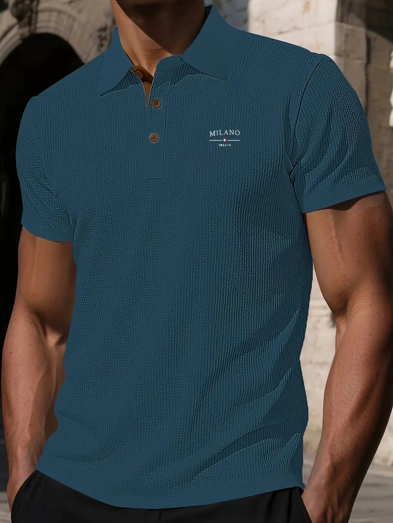 Men's short-sleeved polo shirt in teal with textured knit, brown buttons, Milano Italia logo.