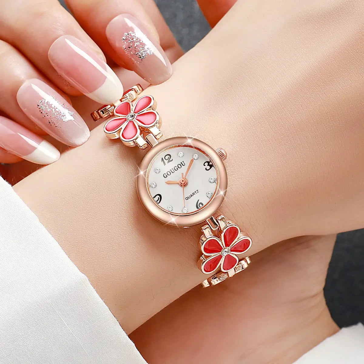 Ladies GOUGOU quartz wristwatch with rose-gold flower bracelet and two pink enamel flower charms, crystal markers