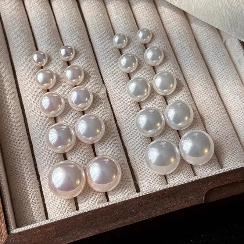 Pearl earrings by Simples Market; 925 sterling silver white lustrous studs in assorted sizes.