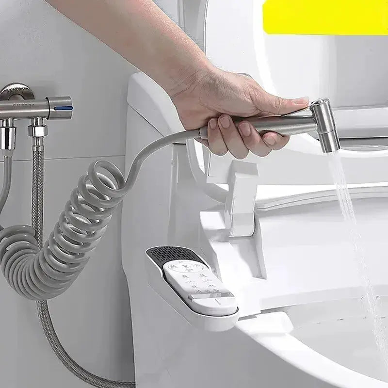 Simples Market handheld stainless steel bidet sprayer with coiled hose attached to toilet