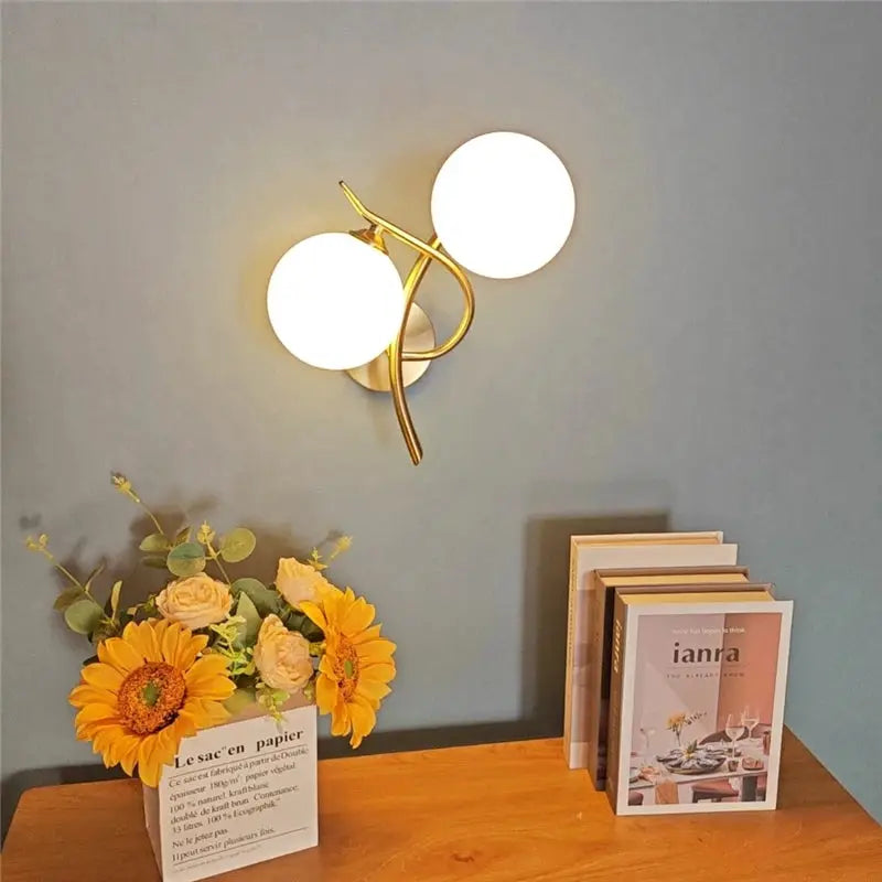 Nordic modern iron wall lamp with gold finish and two white glass globes