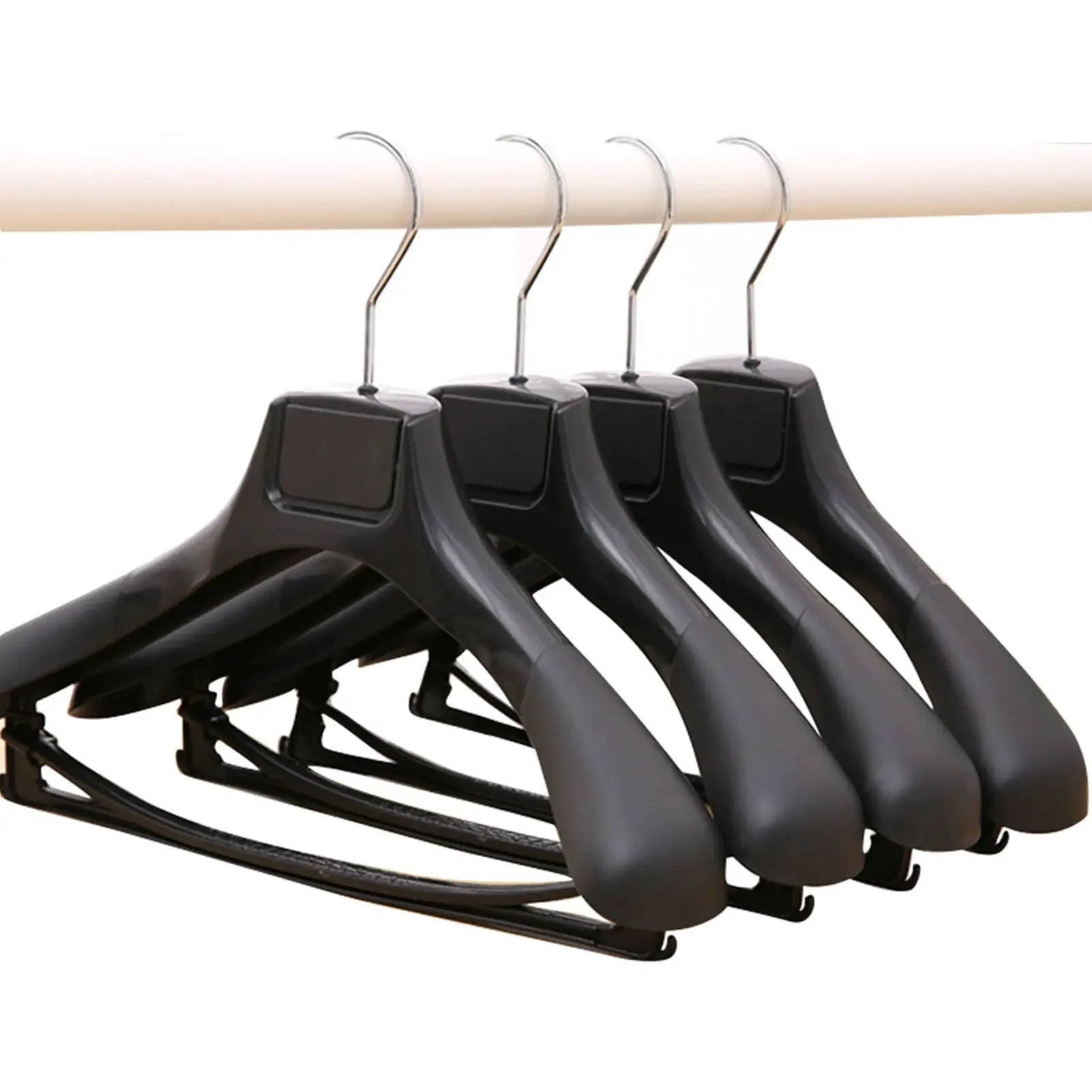 Wide-shoulder black plastic clothing hangers on a wardrobe rod; 4-pack