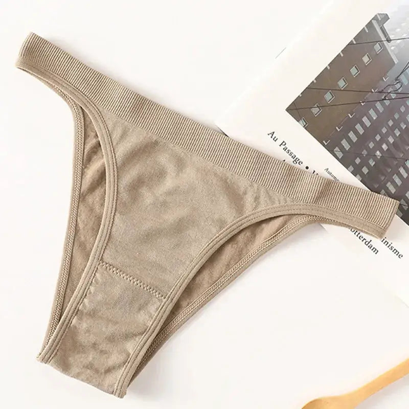 Women ribbed low-rise thong underwear in beige with breathable cotton gusset, high-leg cut.
