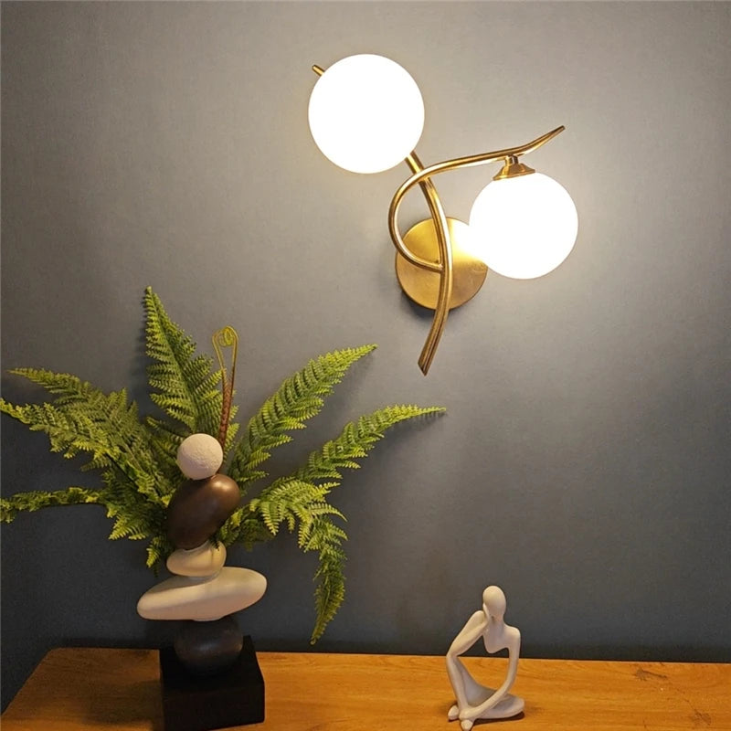 Nordic iron wall lamp sconce with two frosted glass globes in brass finish, LED G9.