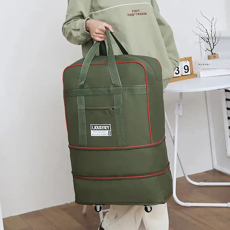 Folding travel bag on swivel wheels, olive green with red piping and top handles