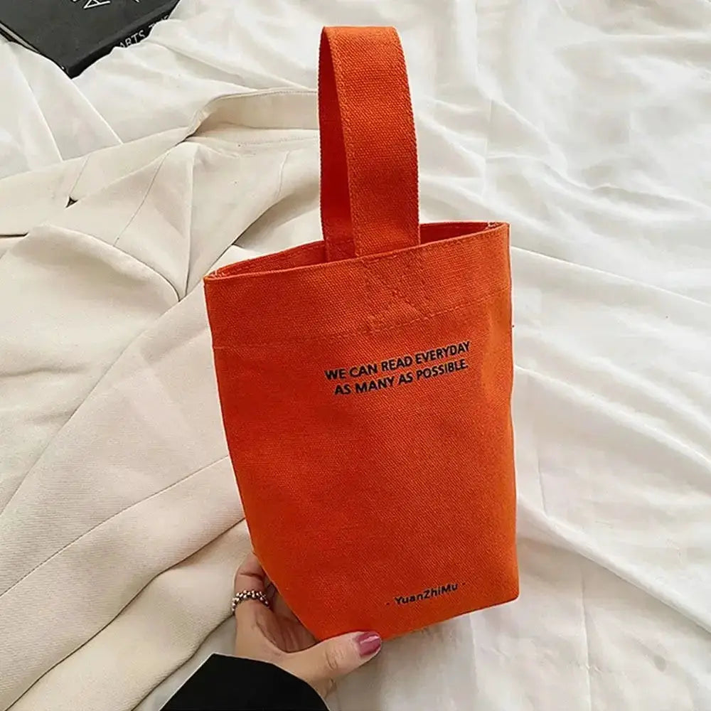 Orange canvas crossbody tote bag with a single top handle, YuanZhiMu logo visible
