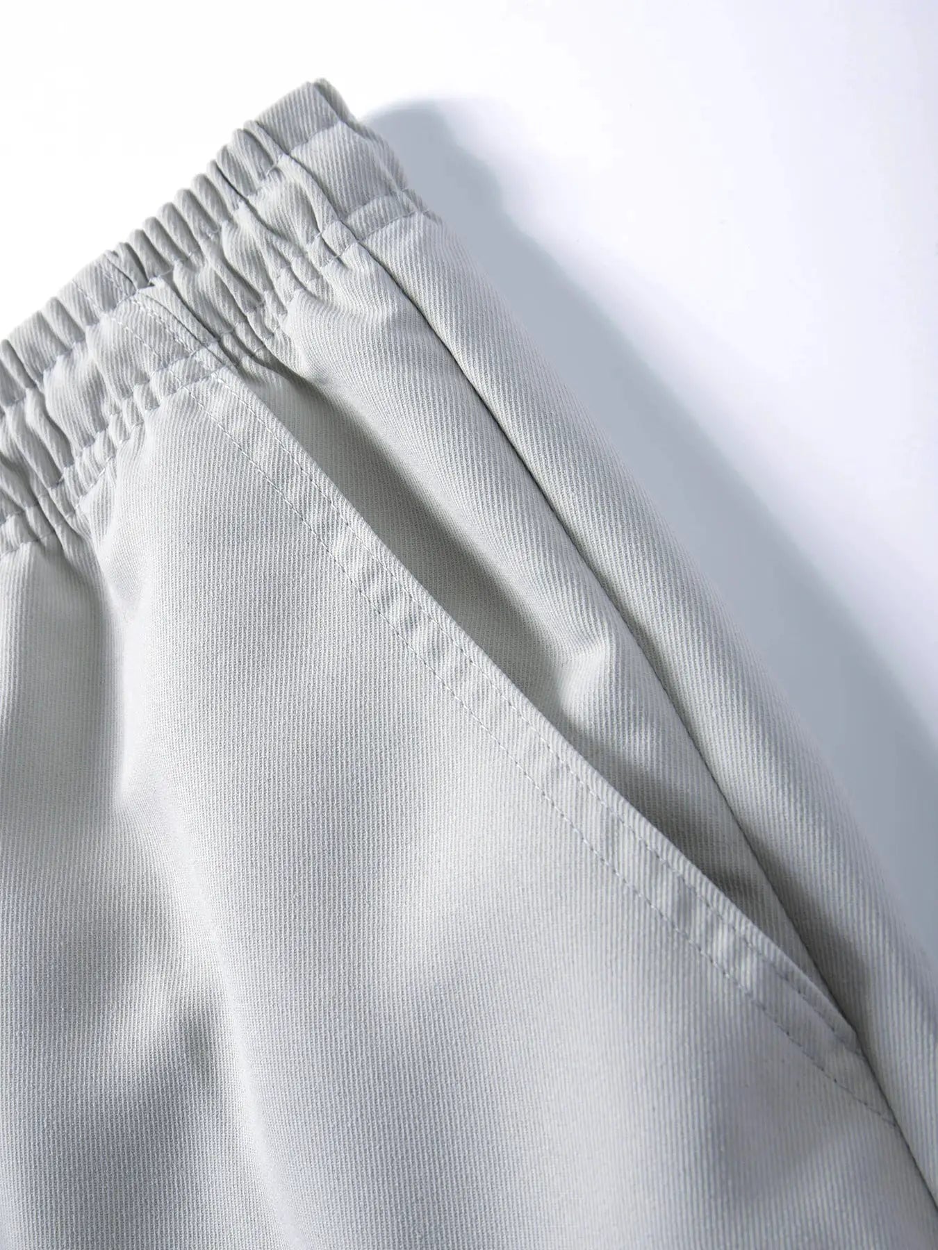 Men's light gray cargo joggers with elastic drawstring waist