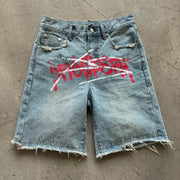 Y2K graffiti jorts in blue distressed denim with frayed hems, unisex baggy fit.