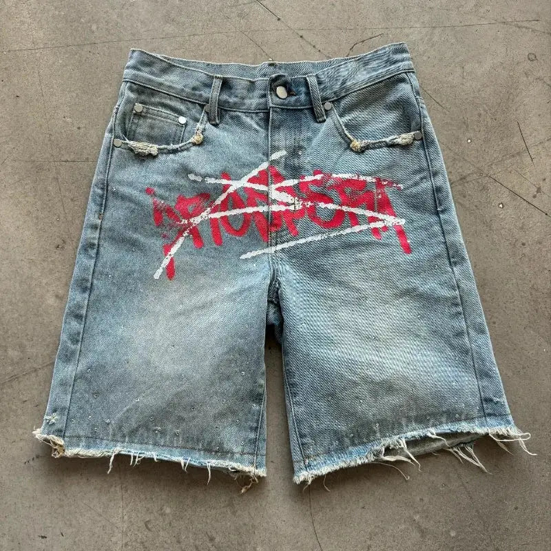 Y2K graffiti jorts in blue distressed denim with frayed hems, unisex baggy fit.
