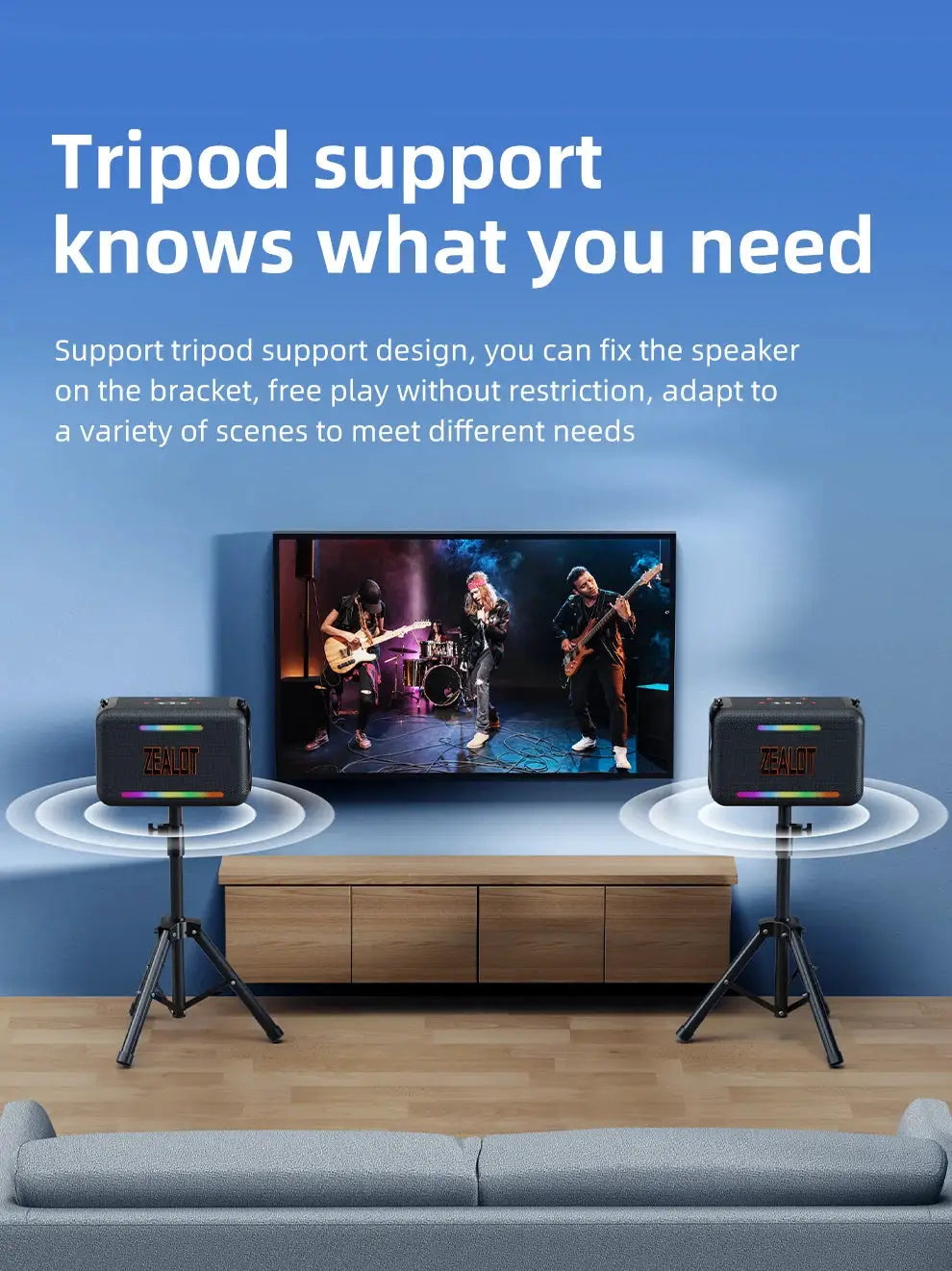 Two black ZEALOT-S95 waterproof Bluetooth speakers on tripod stands beside a TV, with rainbow LED accents.