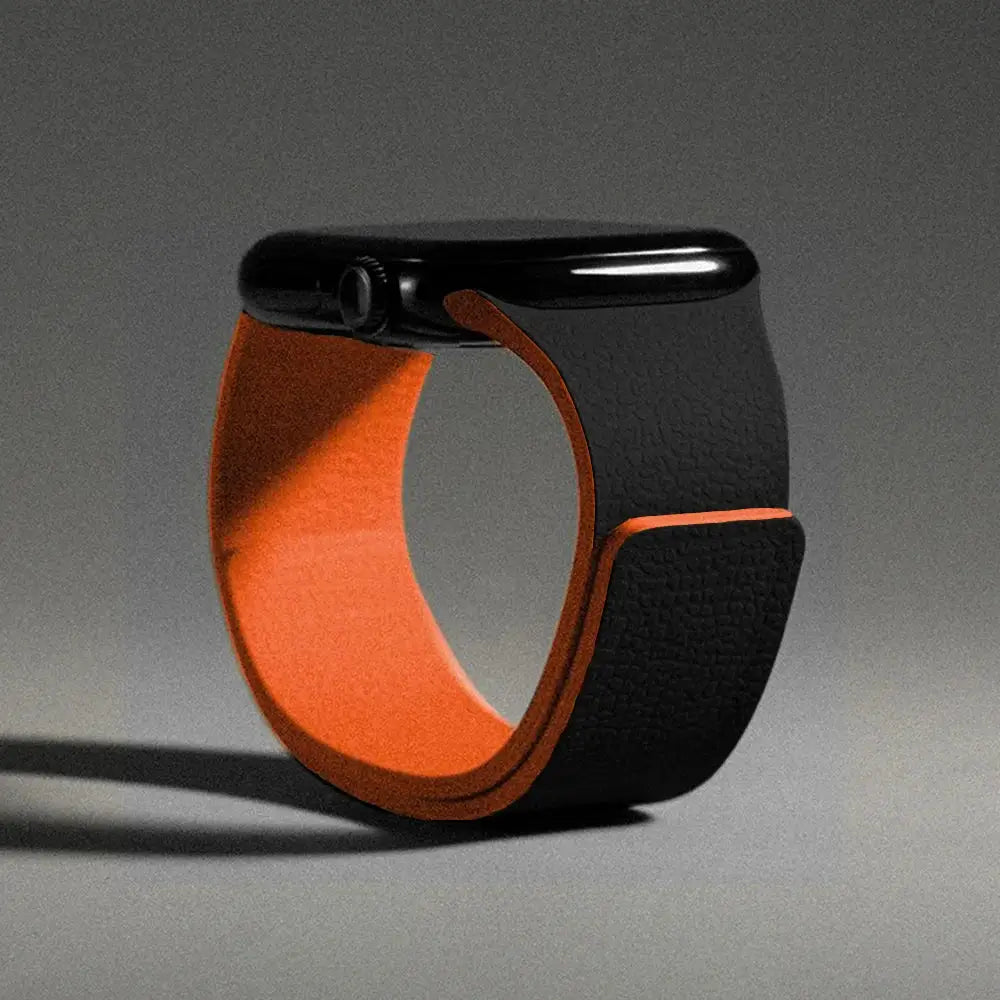 Simples Market silicone magnetic strap for Apple Watch, black exterior with orange inner lining, fits 40–49mm models.