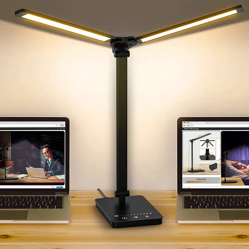 Double Head LED Desk Lamp with dual swing-arms, black finish, placed between two laptops