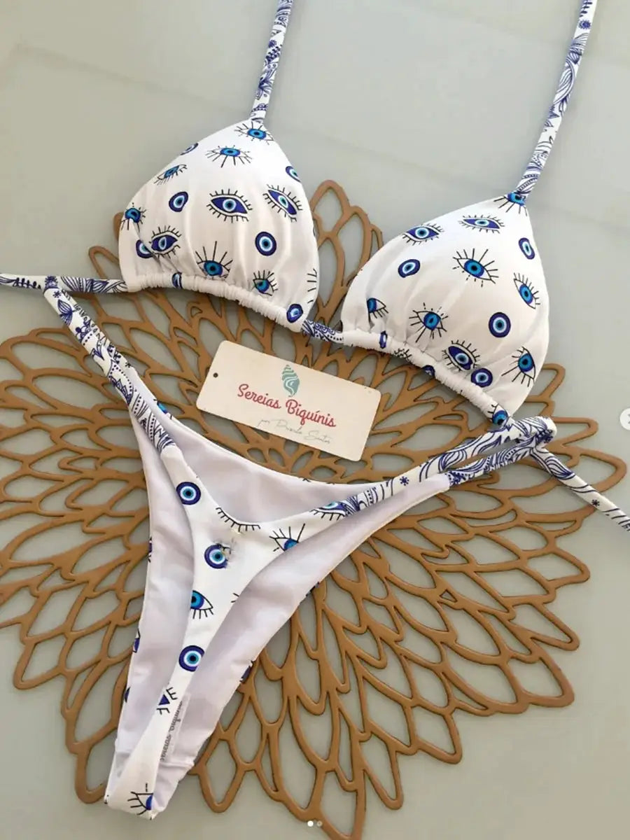 Simples Market micro bikini set, white fabric with blue eye pattern, triangle halter top and thong bottoms