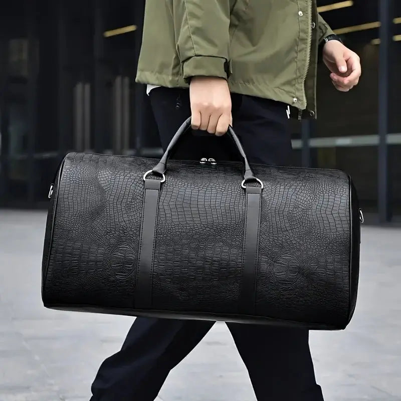 Large capacity crocodile-textured black travel duffel bag carried by a person