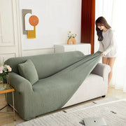 Simples Market elastic jacquard sofa cover on a gray-green L-shaped sectional, stretch slipcover for living room 3–4 seats