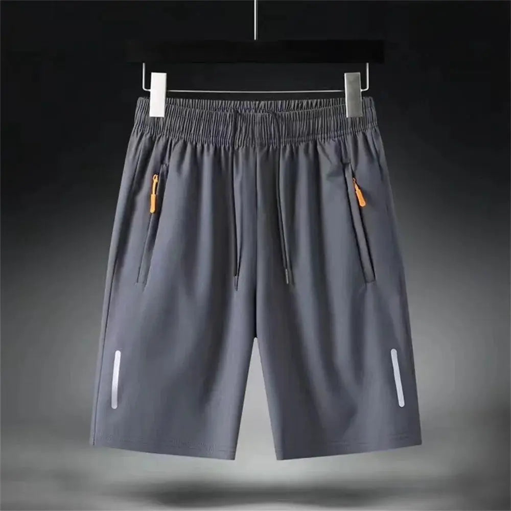 Men's gray ice-silk gym shorts with zip pockets, drawstring waist and reflective leg accents.