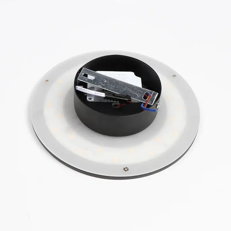 Round aluminum LED wall lamp with mounting hardware for indoor living room lighting.