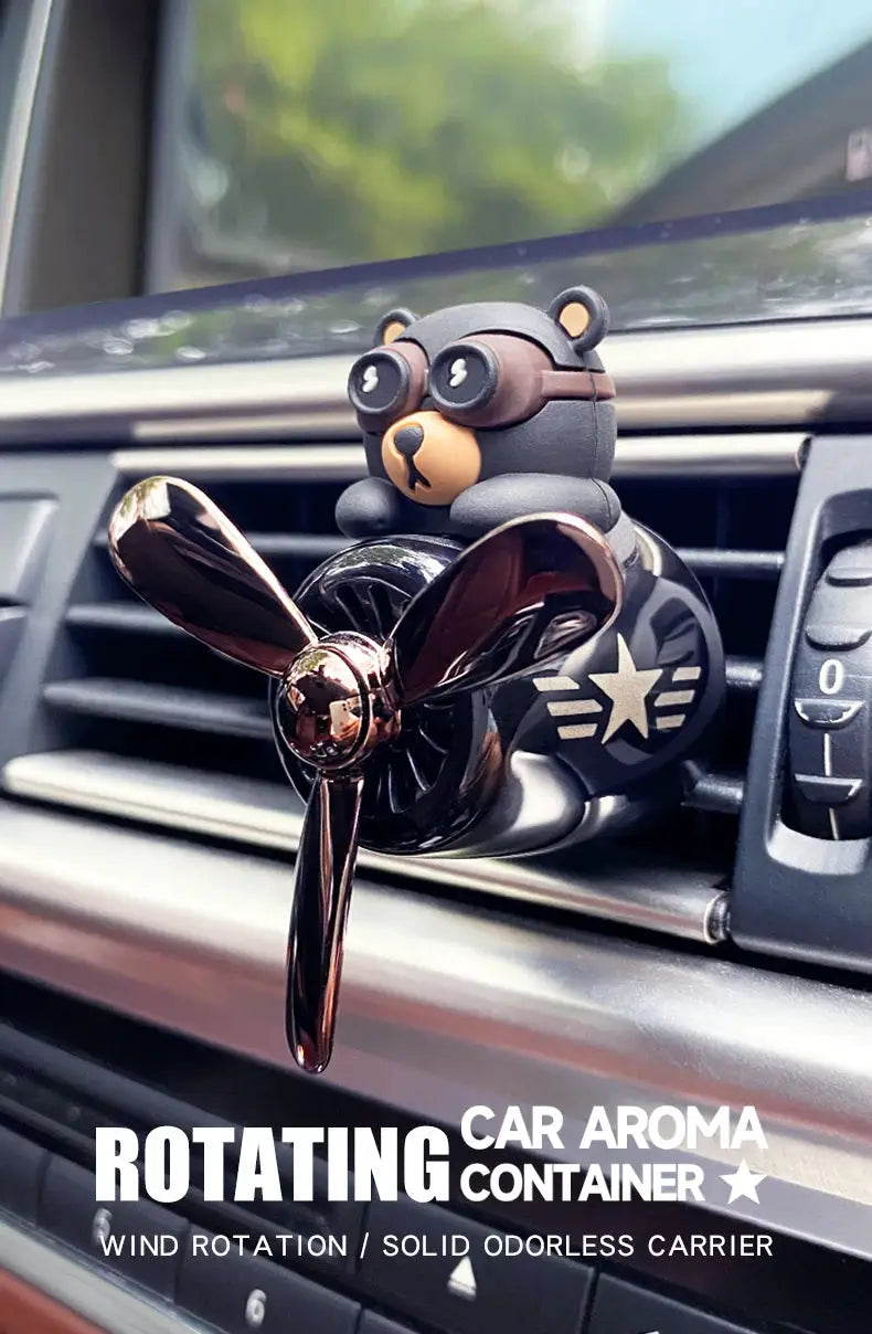 Simples Market rotating car air freshener with a gray bear pilot on bronze propeller vent clip