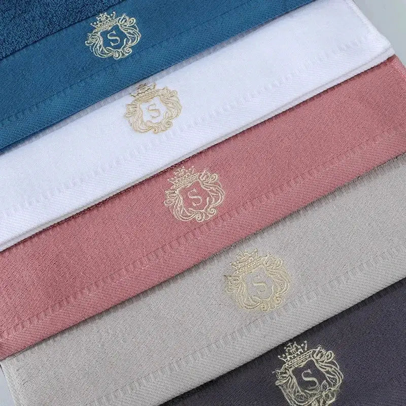 Cotton towel set by Simples Market; 5-pack in assorted colors with embroidered gold crest
