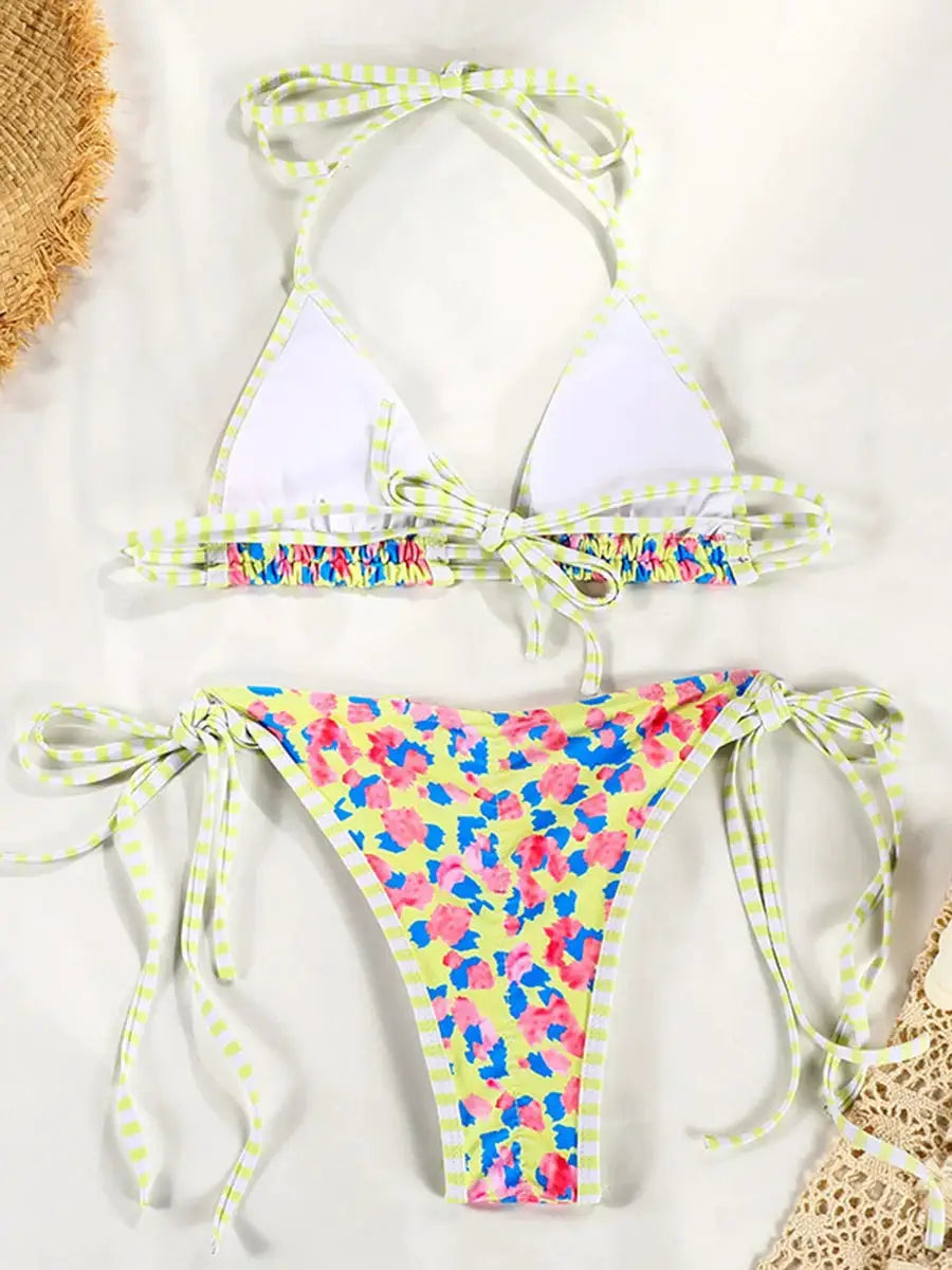 Simples Market two-piece bikini set with white triangle top neon-striped trim and floral-print bottoms; tie sides.