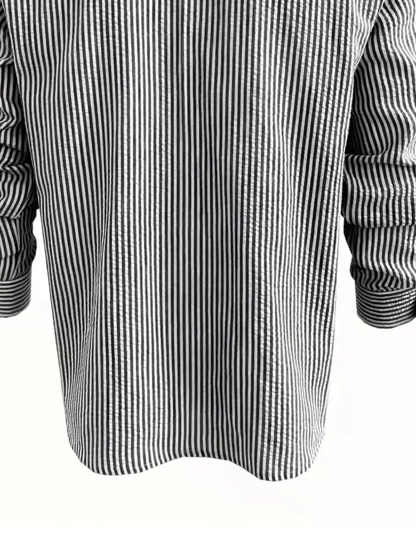 Men's long-sleeve striped shirt in black and white vertical stripes with a loose fit.