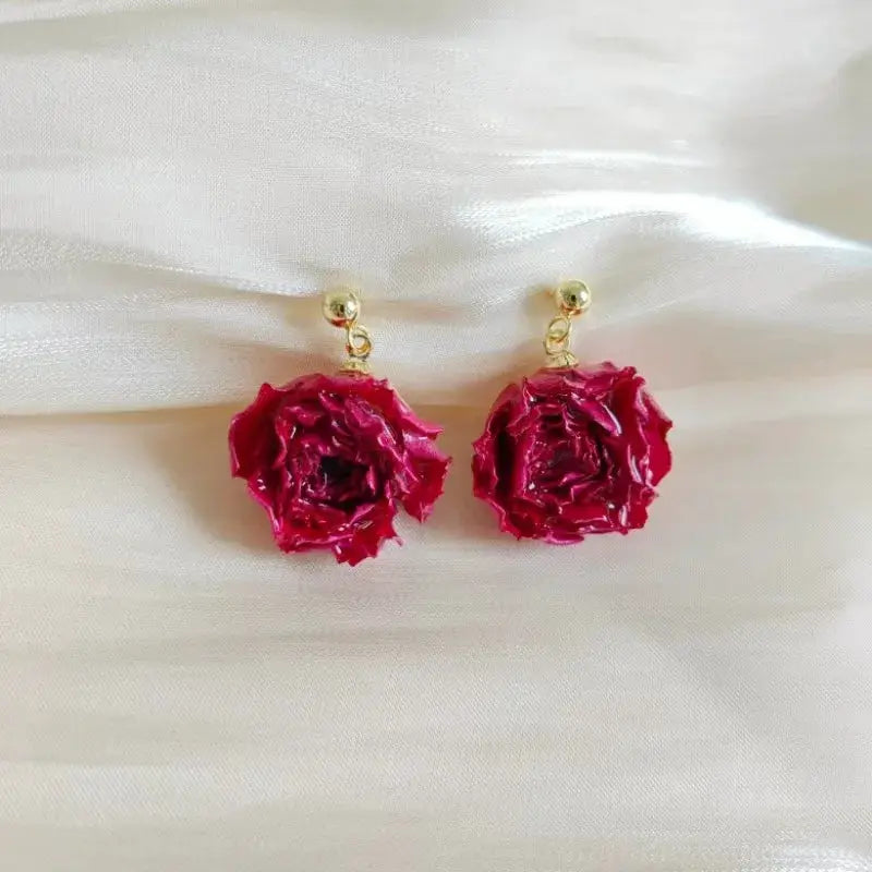 Elegant Immortal Rose Earrings: pink epoxy resin rose drops on gold-tone studs, pair