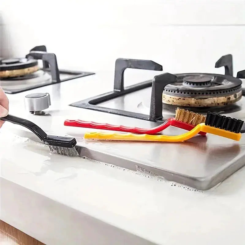 7-inch stainless steel cleaning brush set, 3-piece with yellow and red handles on a kitchen stove