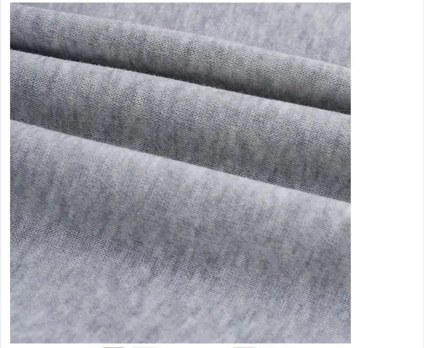 Men's grey sweatpants fabric close-up showing soft knit texture and folds