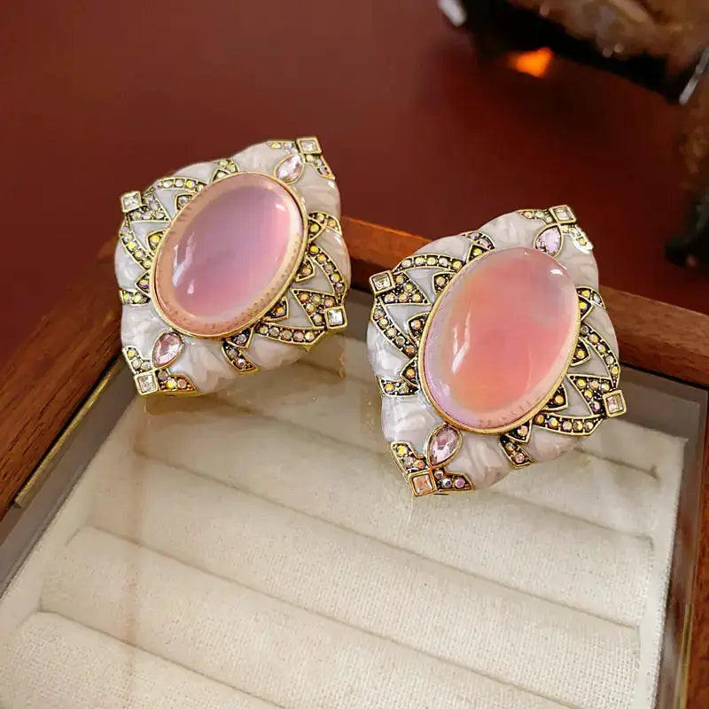 Vintage pink resin oval stud earrings with gold-tone geometric filigree and crystal accents