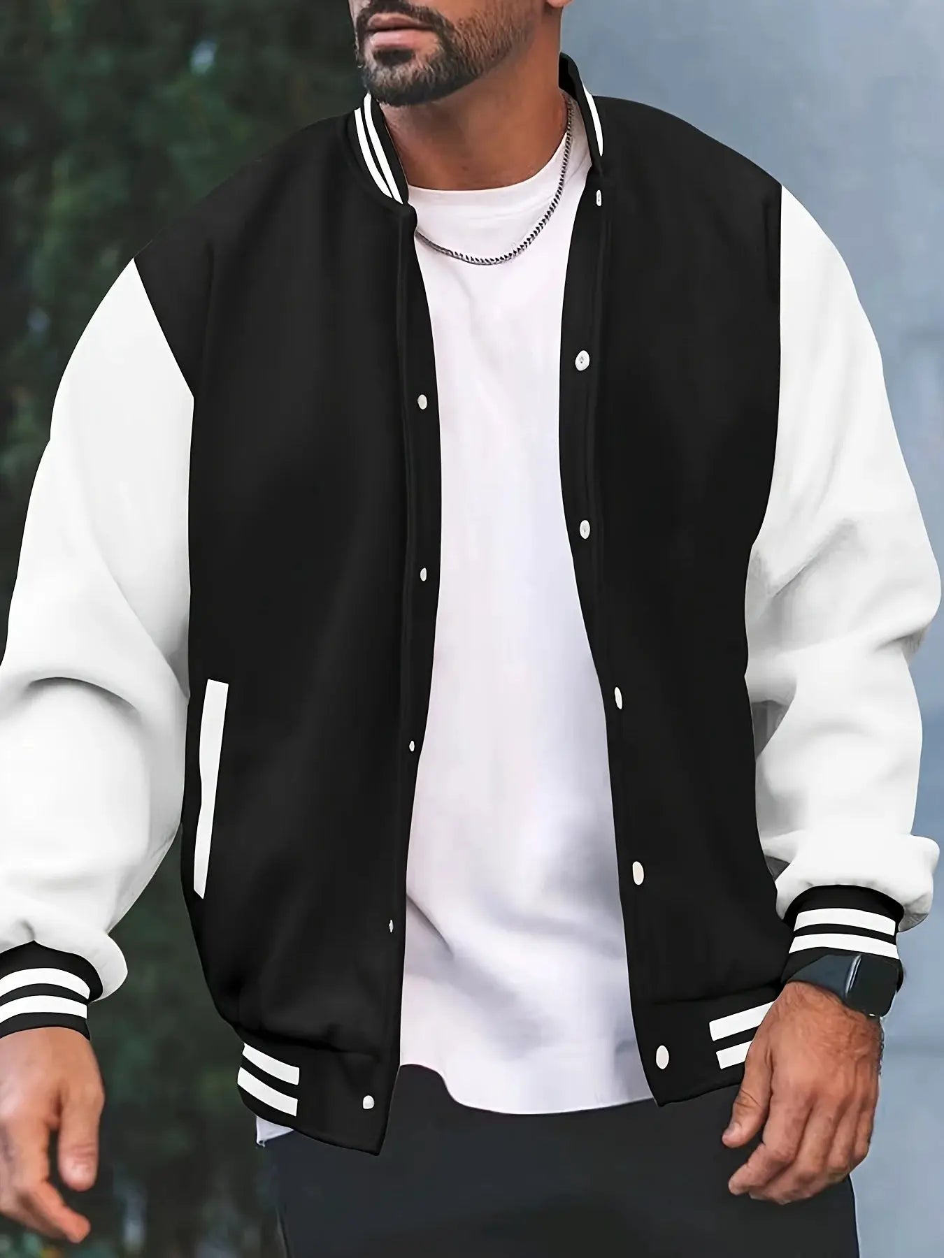 Baseball jacket by Simples Market; black body with white sleeves, varsity striped cuffs, snap buttons.