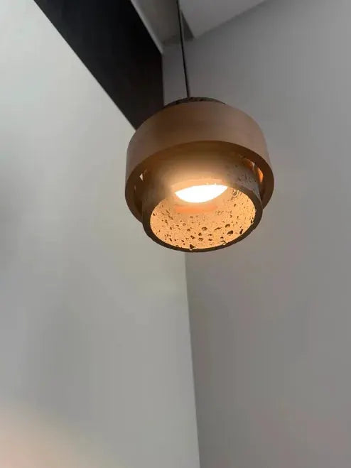 Japanese wabi-sabi style bar pendant lamp with warm brown wood-toned shade and perforated bottom.