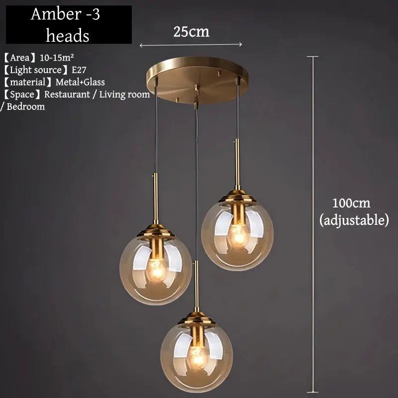 Pendant chandelier with three amber glass globes in brass finish