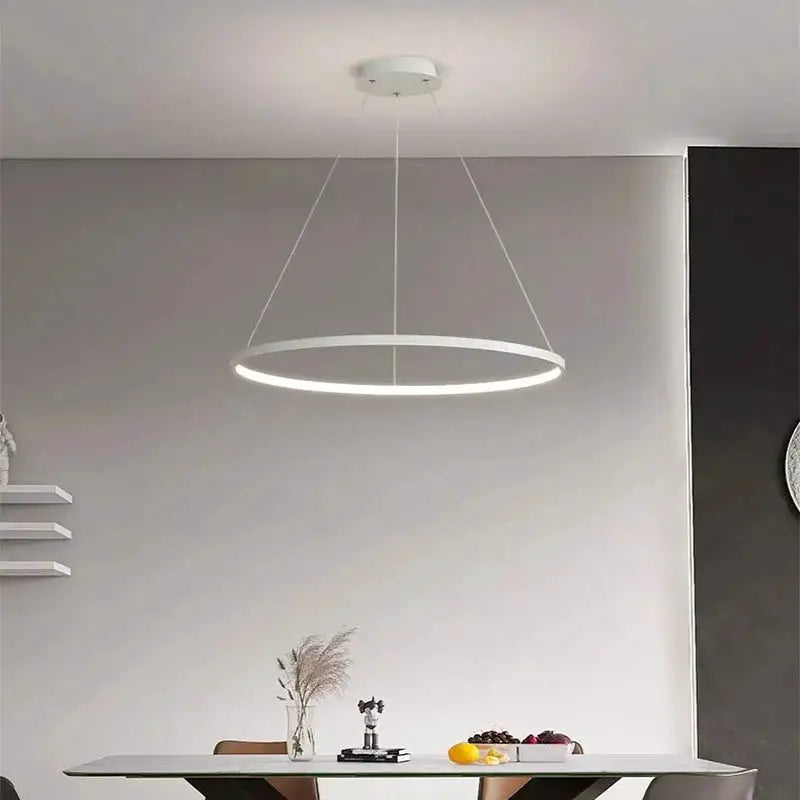 Modern round LED pendant light, white ring with LED glow, minimalist indoor chandelier.