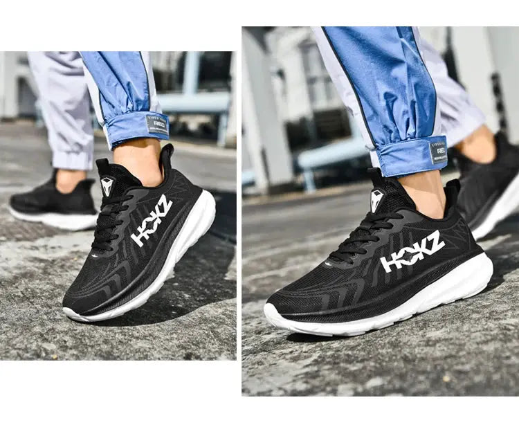 Pair of black men's running shoes with breathable mesh and white rubber soles, visible side logo