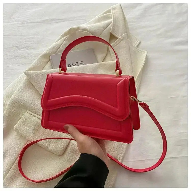 Simples Market red PU leather handbag with top handle and crossbody strap