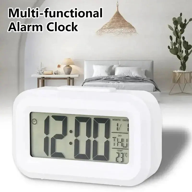 White LED digital alarm clock with backlight; displays time, date, day and temperature for bedroom desk.