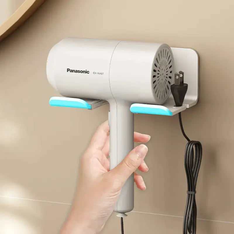 Hair dryer holder, white with blue accents, wall-mounted, holding a Panasonic hair dryer.