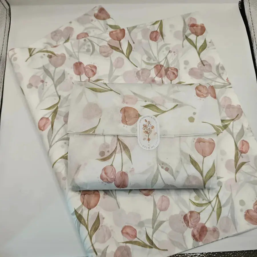 Tulip-pattern tissue paper sheets with pink flowers and green leaves on white background; pack for gift wrapping