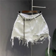 White irregular denim mini skirt with distressed hem and silver chain belt