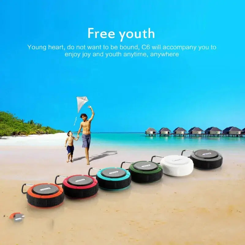 Simples Market waterproof wireless portable Bluetooth speakers, six colorful units lined up on a beach.