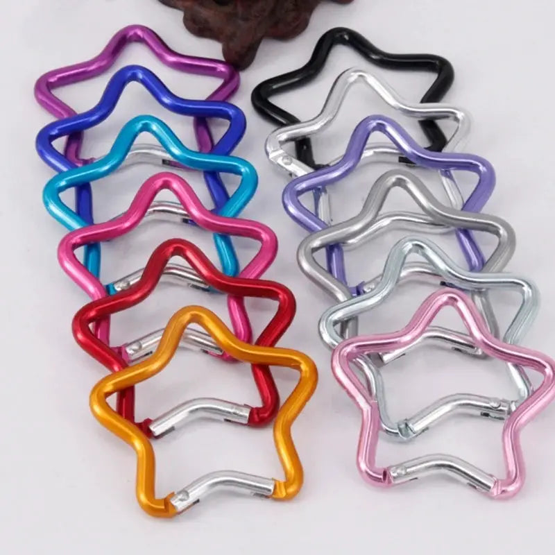 Aluminum star-shaped carabiner clips in assorted colors for backpacks, camping, and hiking