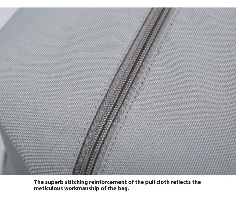 Large capacity travel gym bag close-up of grey fabric and heavy-duty zipper.